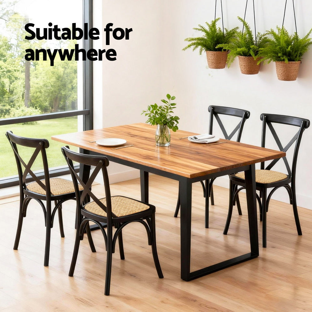 Dining chairs with black X-back frames and woven rattan-style seats.