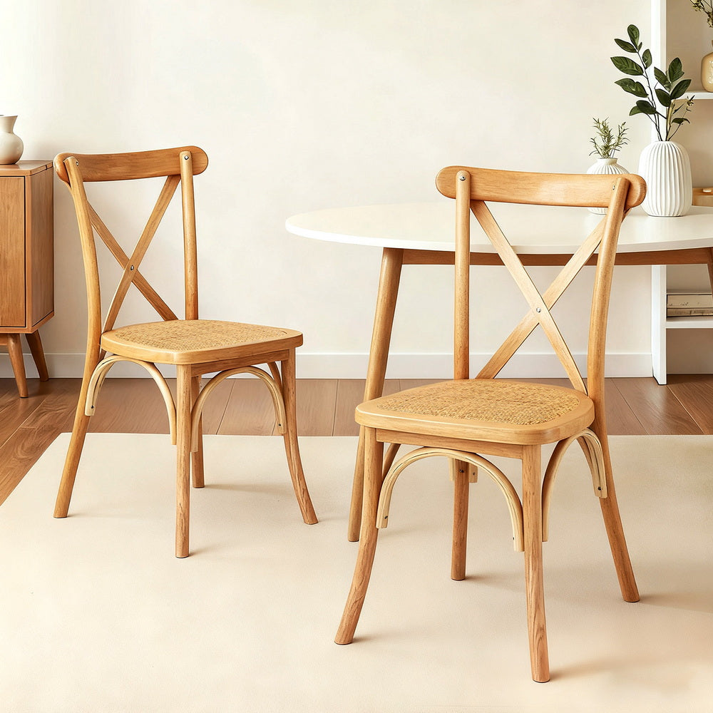Set of wood dining chairs with woven seats and cross-back frames on curved legs