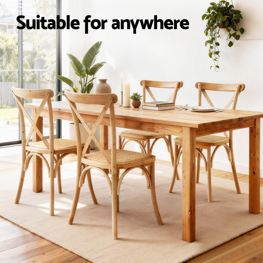 Wooden dining chair with curved legs, cross-back frame, and woven rattan seat