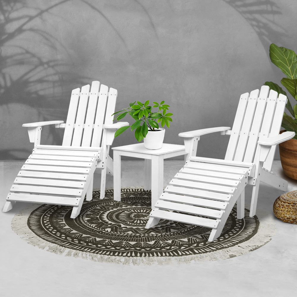 White Adirondack chairs around small patio table with potted plant