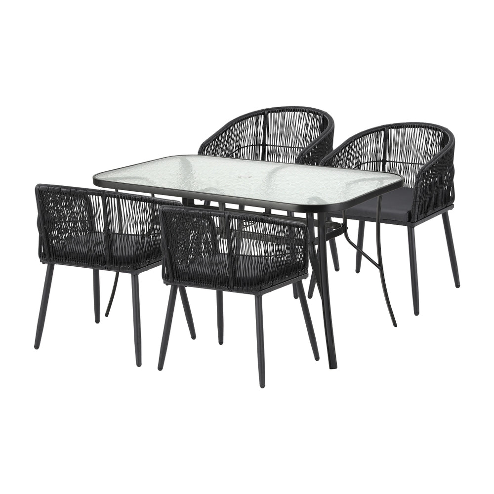 Black outdoor dining table with clear glass top and four mesh-back chairs