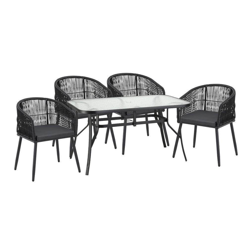 Black outdoor dining set with glass-topped table and four armless woven chairs