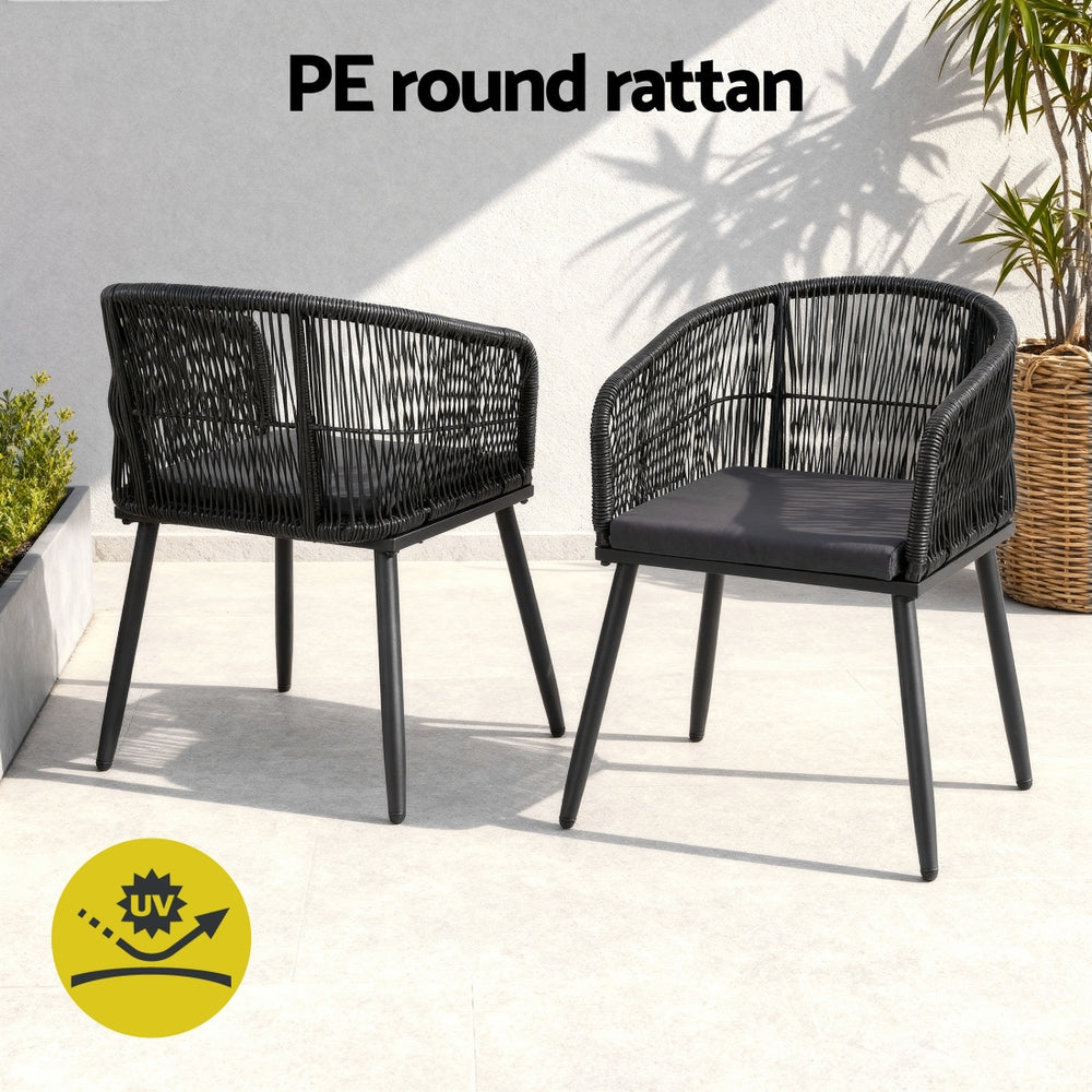 Black woven dining chairs with dark cushions and slim metal legs