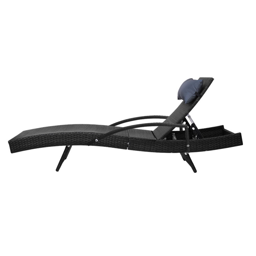 Adjustable outdoor wicker lounge chair with curved armrest supports and black head cushion