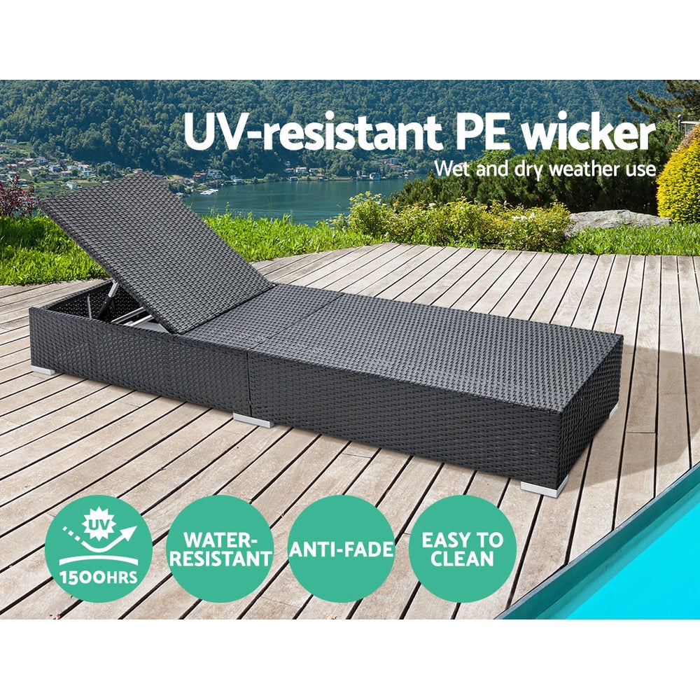 Black PE wicker sun lounger with light gray UV-resistant cushions on outdoor deck