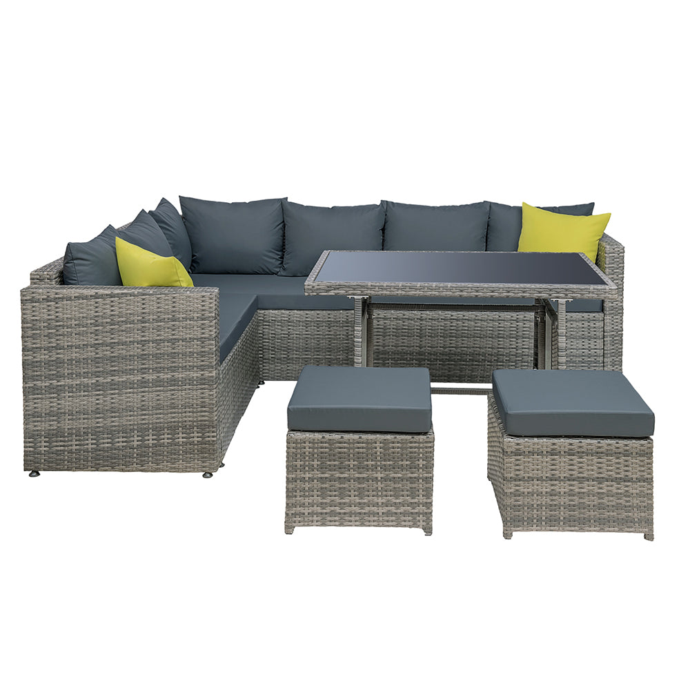 Outdoor dining set with grey wicker-look sectional, dark seat cushions, yellow accent pillows