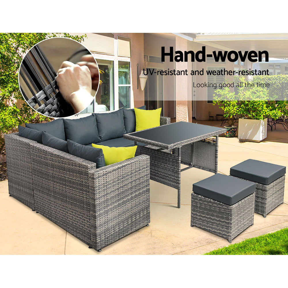 Outdoor dining set with grey wicker-look sofa seating, dark cushions, yellow pillows, table