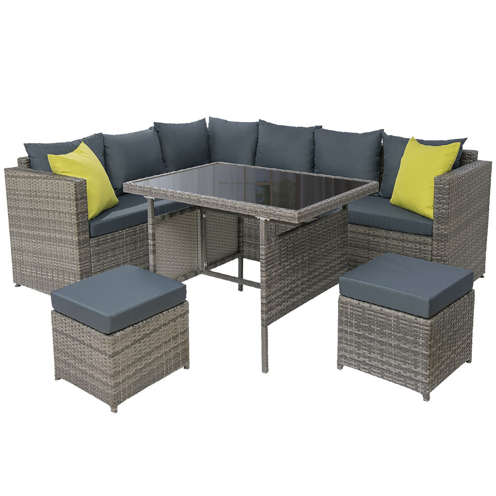Outdoor dining set with grey wicker-look corner sofa, dark cushions, yellow throw pillows