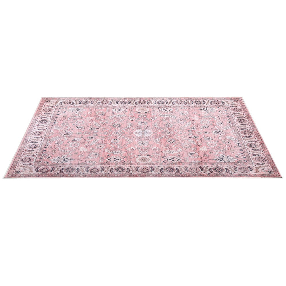 Pink vintage floral area rug with decorative border, rectangular flatlay.