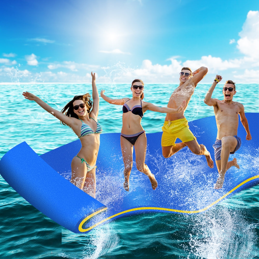 Blue floating foam water mat with yellow seam lines as swimmers jump in water