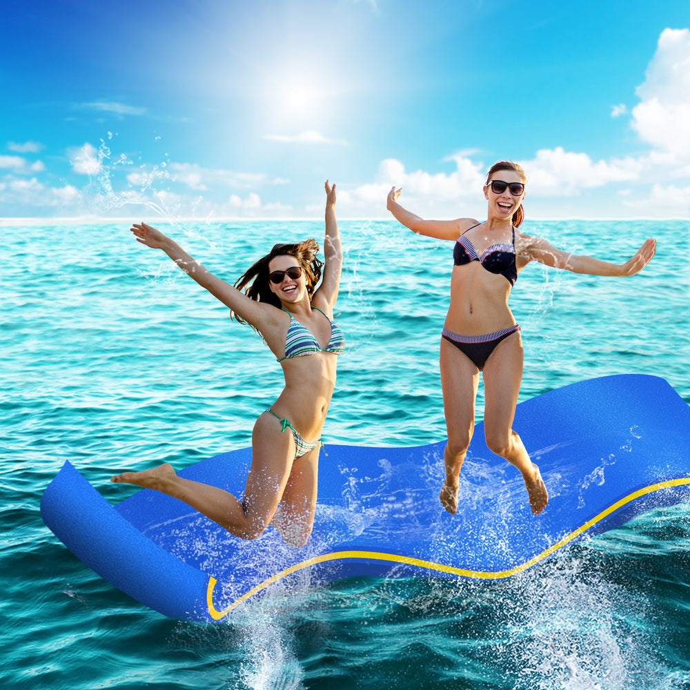Blue floating water mat with yellow border line, in motion on open water