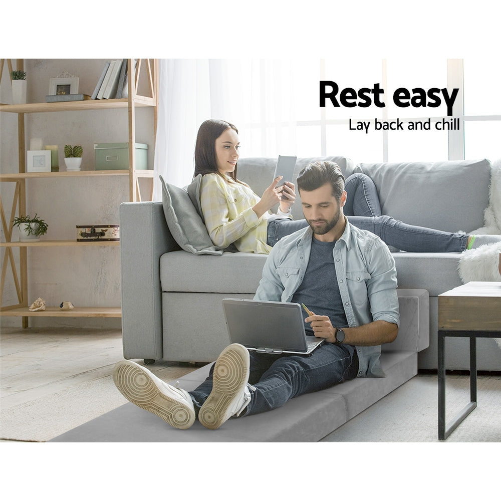 Light grey foldable foam mattress mat laid out on the floor as extra seating