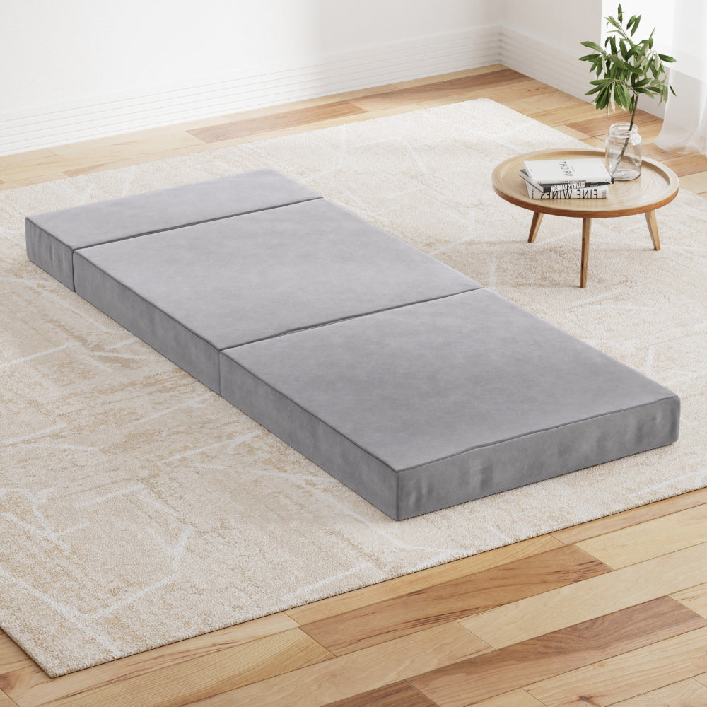 Light grey foldable foam mattress mat with hinged sections, lying flat