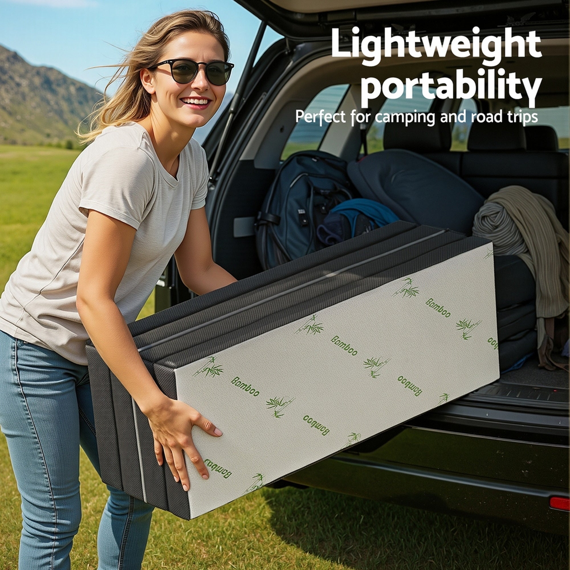 Foldable double mattress held for travel, white bamboo-pattern cover with black sides