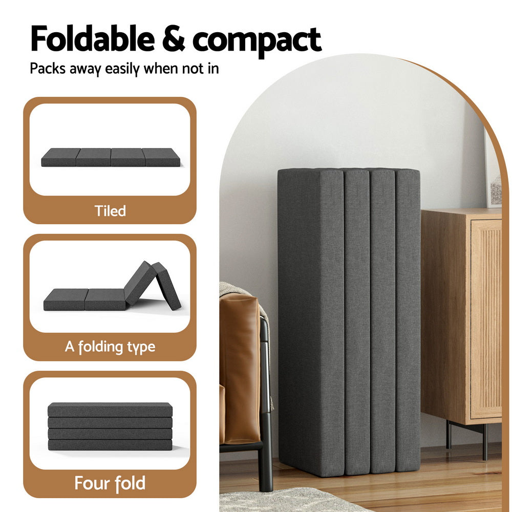 Four-fold folding foam mattress, dark gray, stacked upright for storage