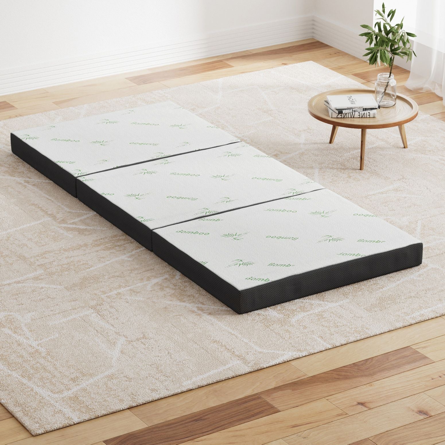 Foldable single mattress with bamboo-print white top and dark gray base, laid flat