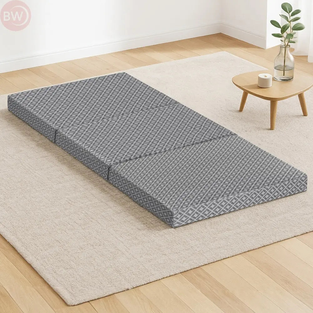Gray trifold folding mattress cushion with geometric jacquard cover, laid flat