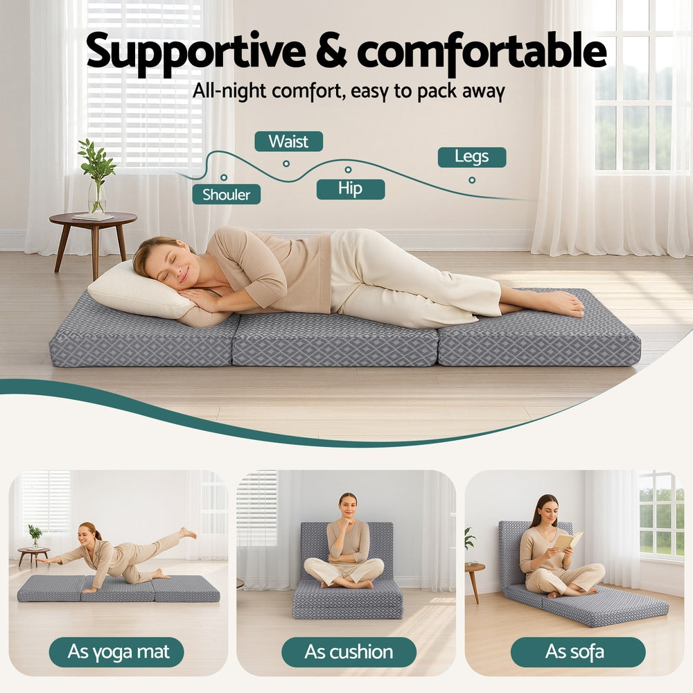 Trifold memory foam mattress with gray geometric cover supporting a sleeping person