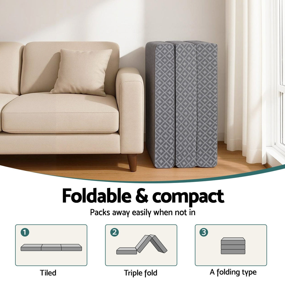 Foldable trifold memory foam mattress in gray geometric cover, folded upright
