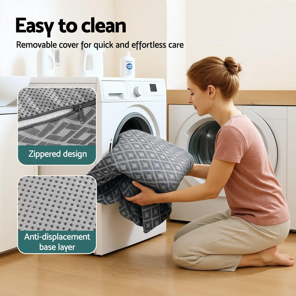 Trifold memory foam mattress with zipped removable cover beside washing machine