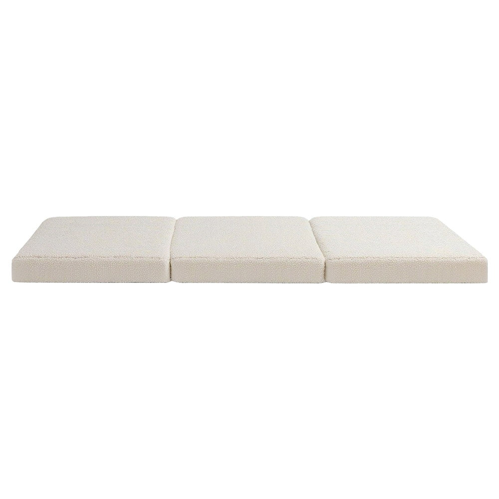 Folded 3-panel foam mattress with light beige fabric cover and three hinged sections.