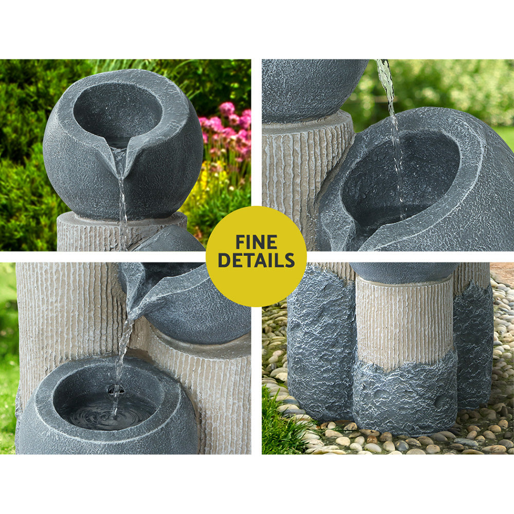 Grey 3-tier cascading water fountain, close-up of spouts and textured stacked pots