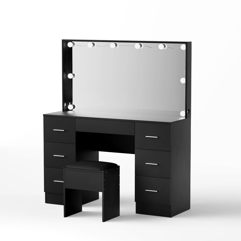 Black dressing table vanity with lit mirror, six drawers, and matching cushioned stool