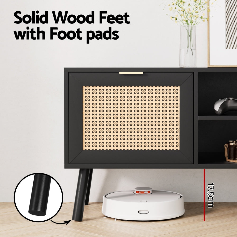 Black TV cabinet with rattan-look drawer panel and solid legs with foot pads