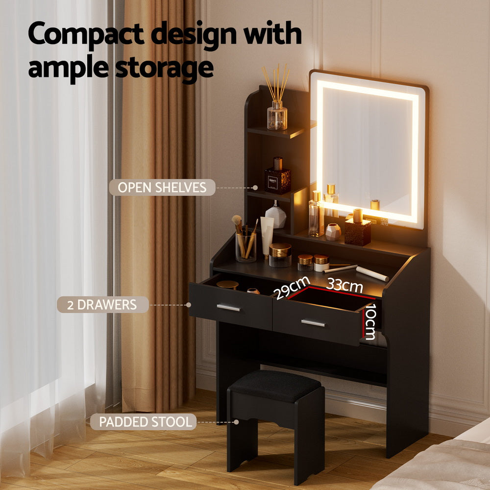 Compact black dressing table set with LED mirror, drawers, open shelves, and padded stool