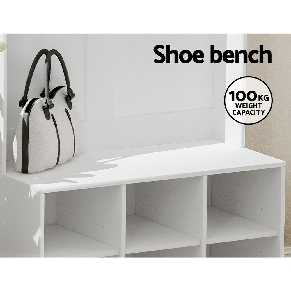 White hall tree shoe bench with open cubby storage compartments below the seat