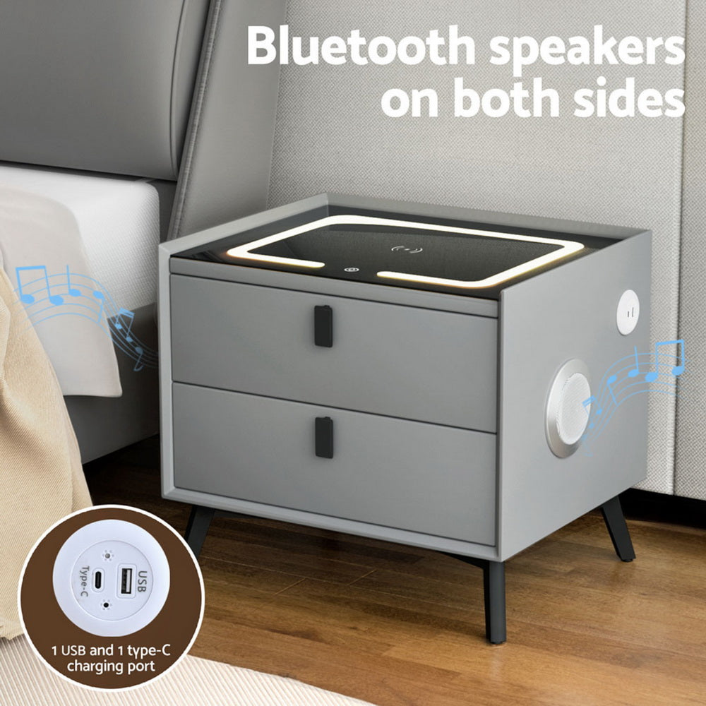 Grey bedside table with side speaker, charging pad, and 2 drawers