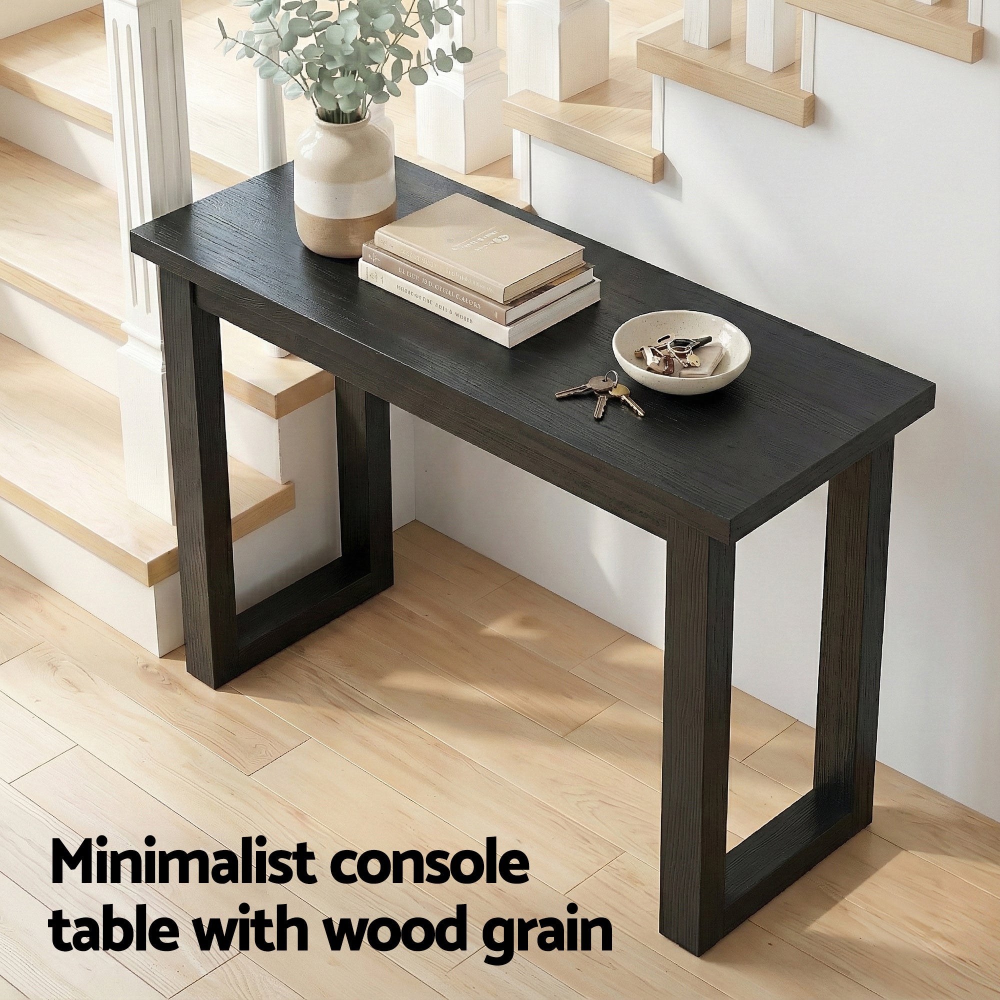 Black console table with wood-grain top and open frame legs.
