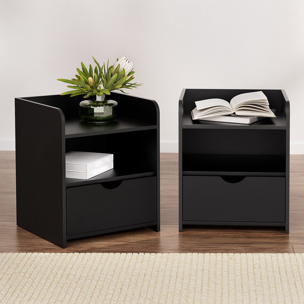 Black bedside tables, each with open shelf and a single drawer
