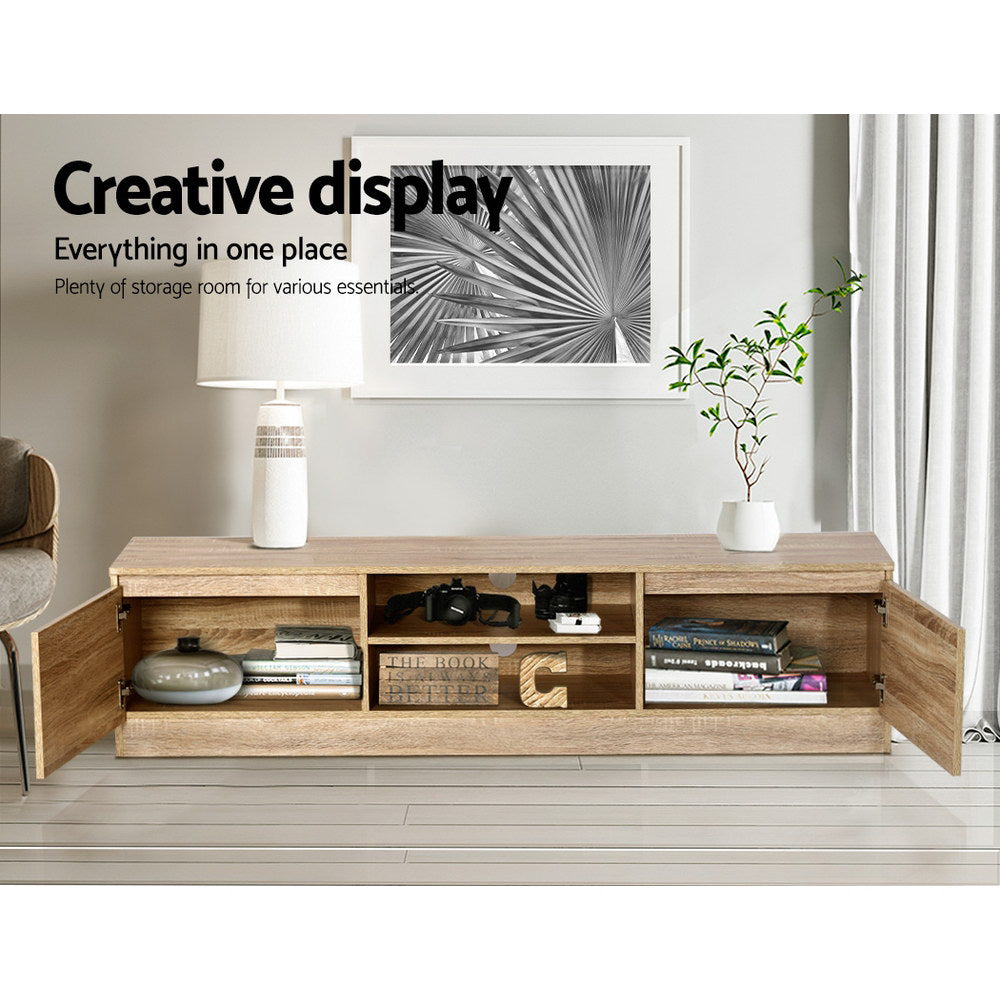 TV cabinet with open center shelves and side storage compartments in light pine wood.