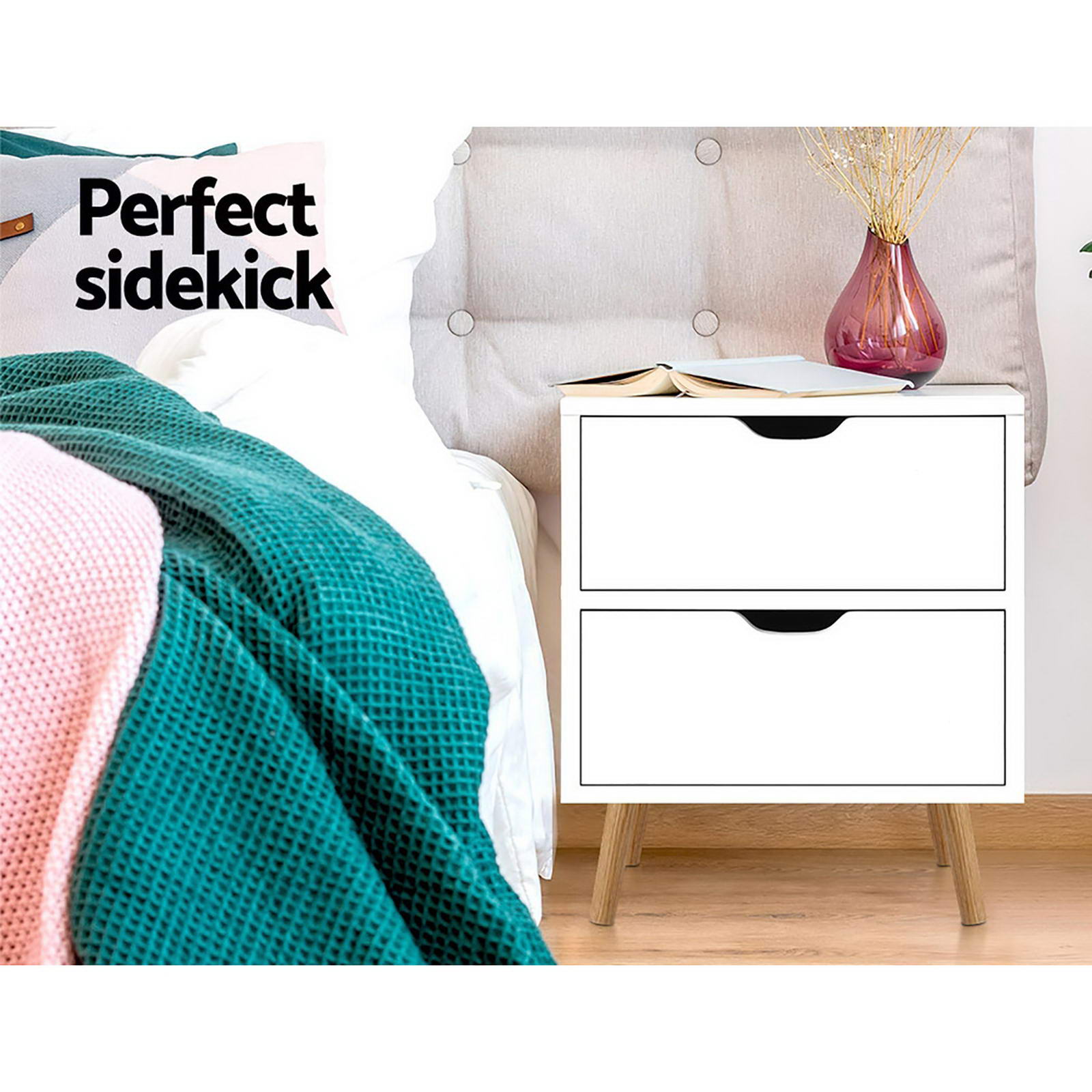 White two-drawer bedside table with black curved handles and wooden legs