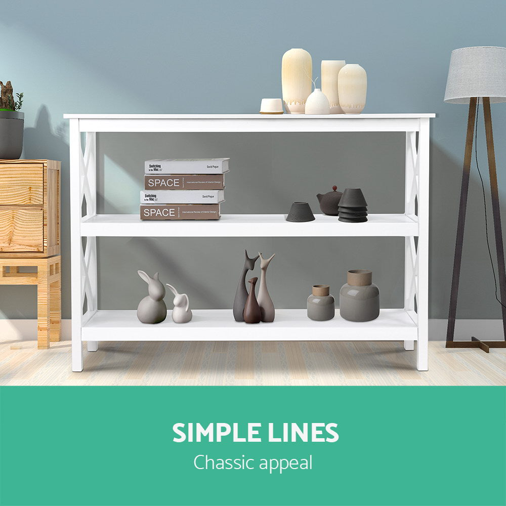 White three-tier console table with open shelving and decorative items