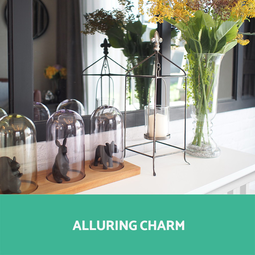 White console table with decor items on top and open shelves; 'Alluring charm' overlay