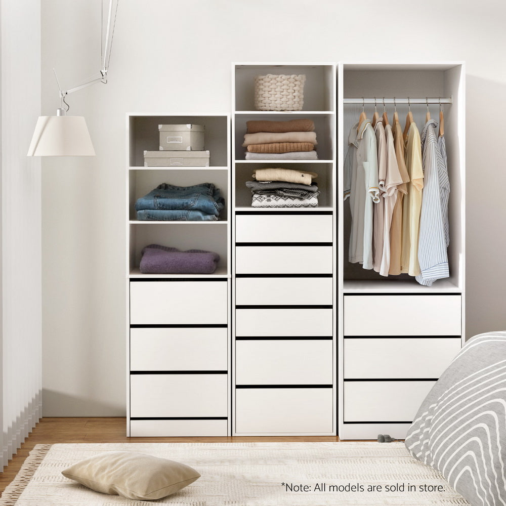 White wardrobe cabinet with cubby shelves, hanging rail, and three drawer drawers