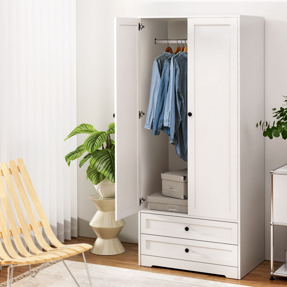 White wardrobe with two open doors, hanging clothes and two bottom drawers