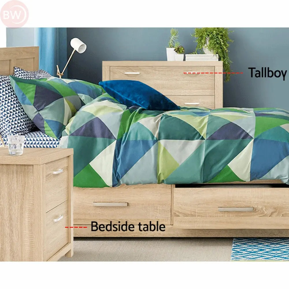 Light wood bedside table with two drawers beside a bed