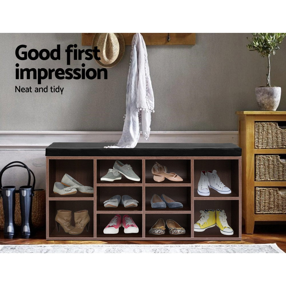 Walnut shoe storage bench with black padded lid and open cube compartments for shoes