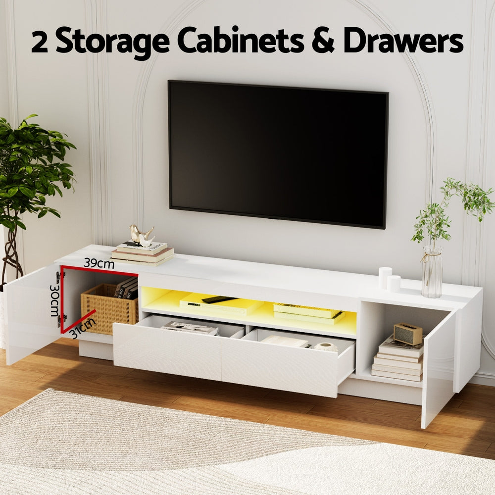 White TV entertainment unit with open storage drawers and blue LED glow