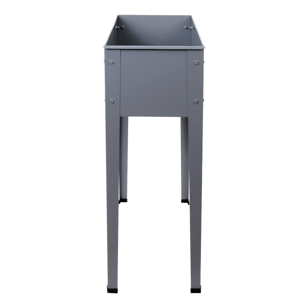 Dark gray elevated planter box with four legs and open planter tub, front view