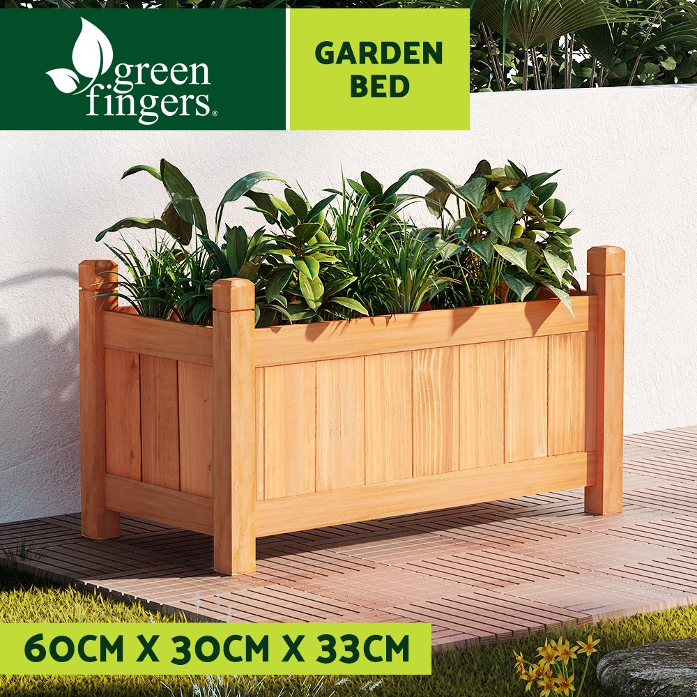 Light wooden raised garden planter box filled with leafy plants and corner posts.