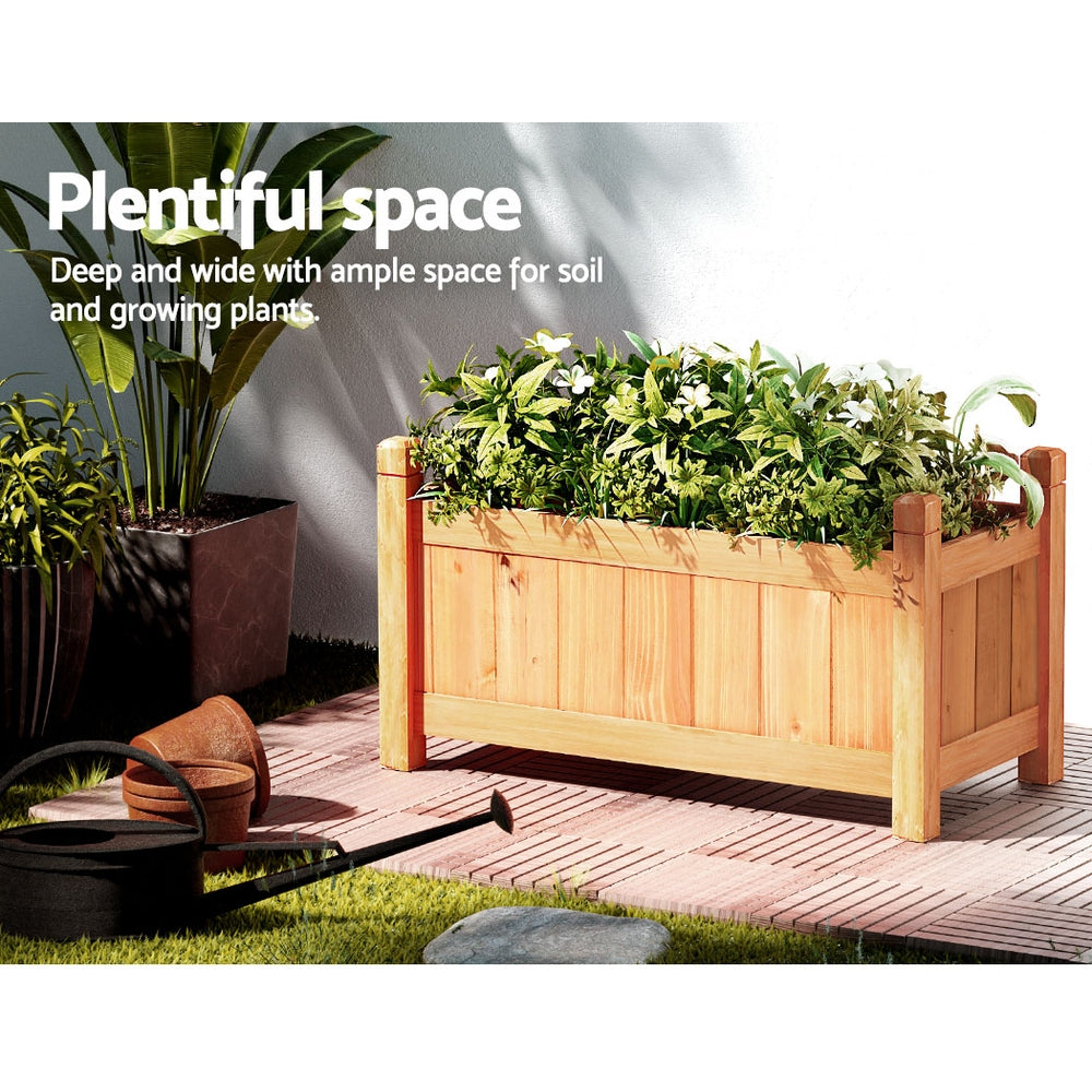 Light wooden raised planter box with dense green herbs, open soil area, and posts.