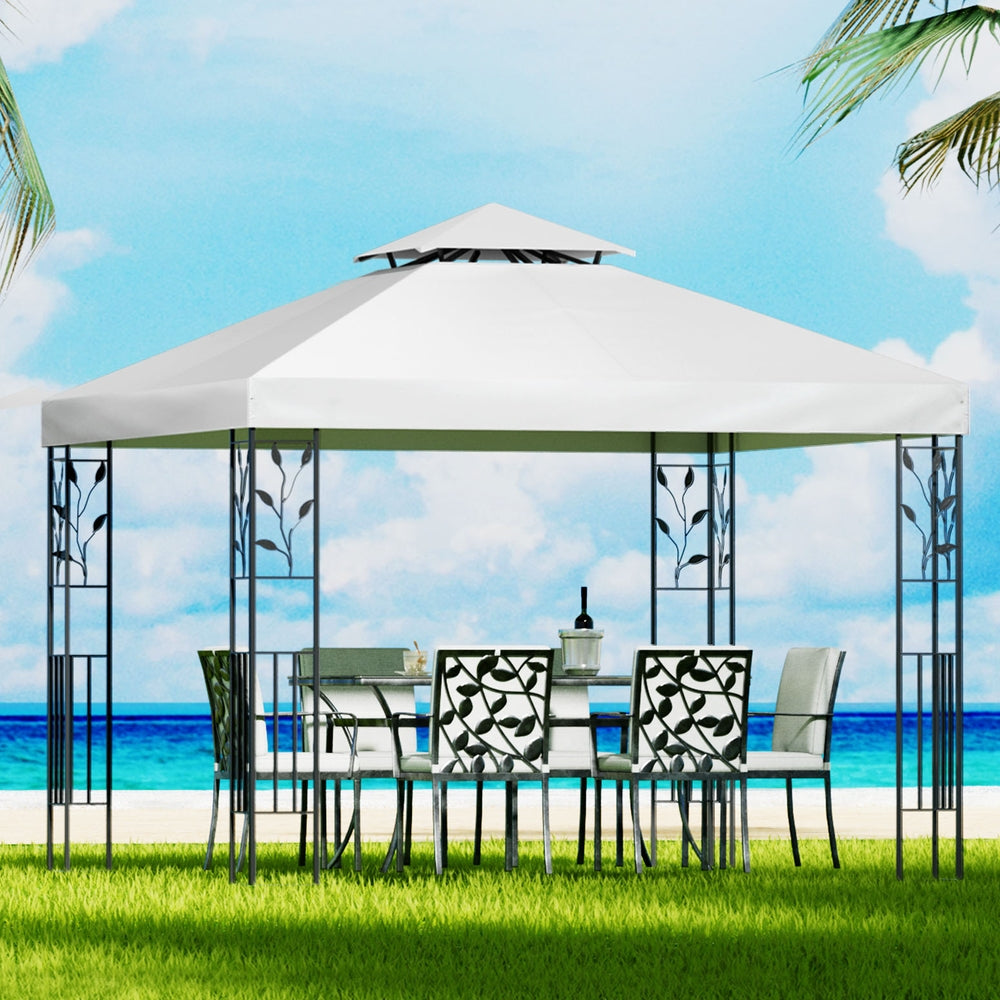 White gazebo canopy with open iron lattice sides over outdoor dining table