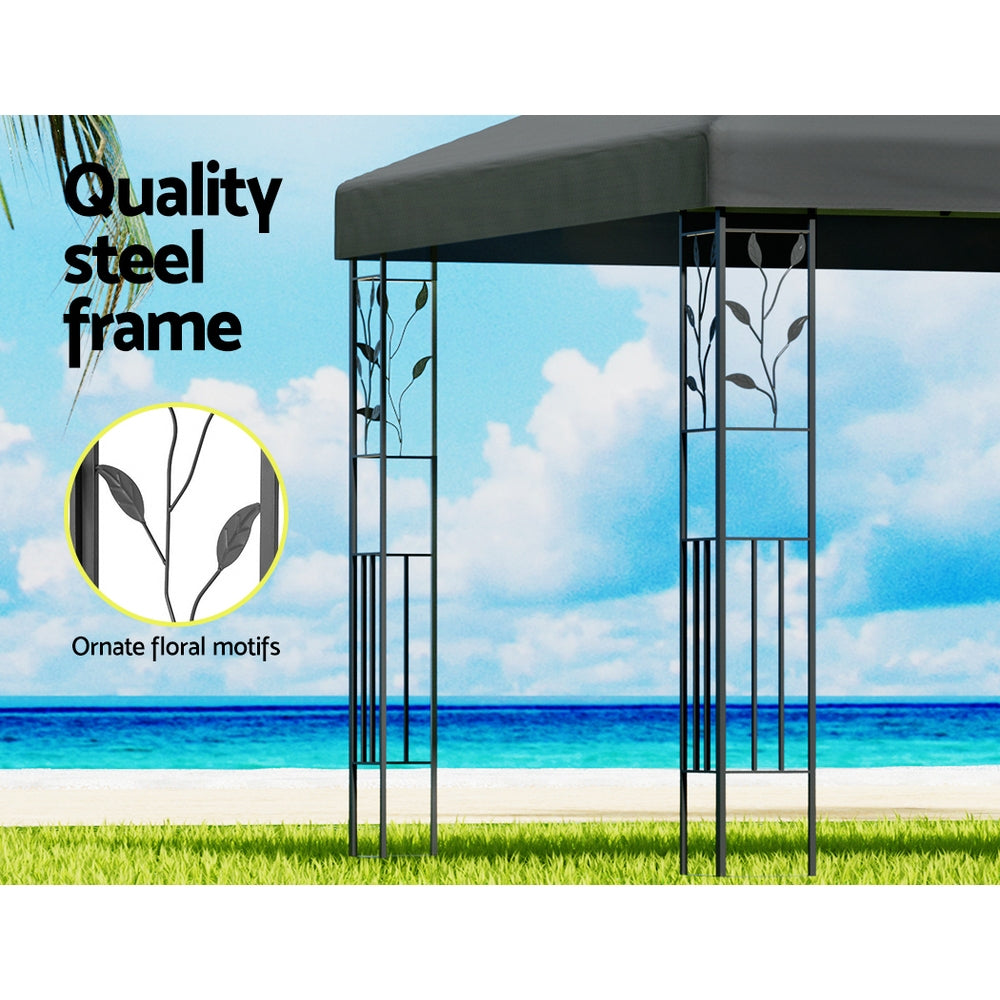 Outdoor gazebo frame with ornate floral detailing and grey canopy top