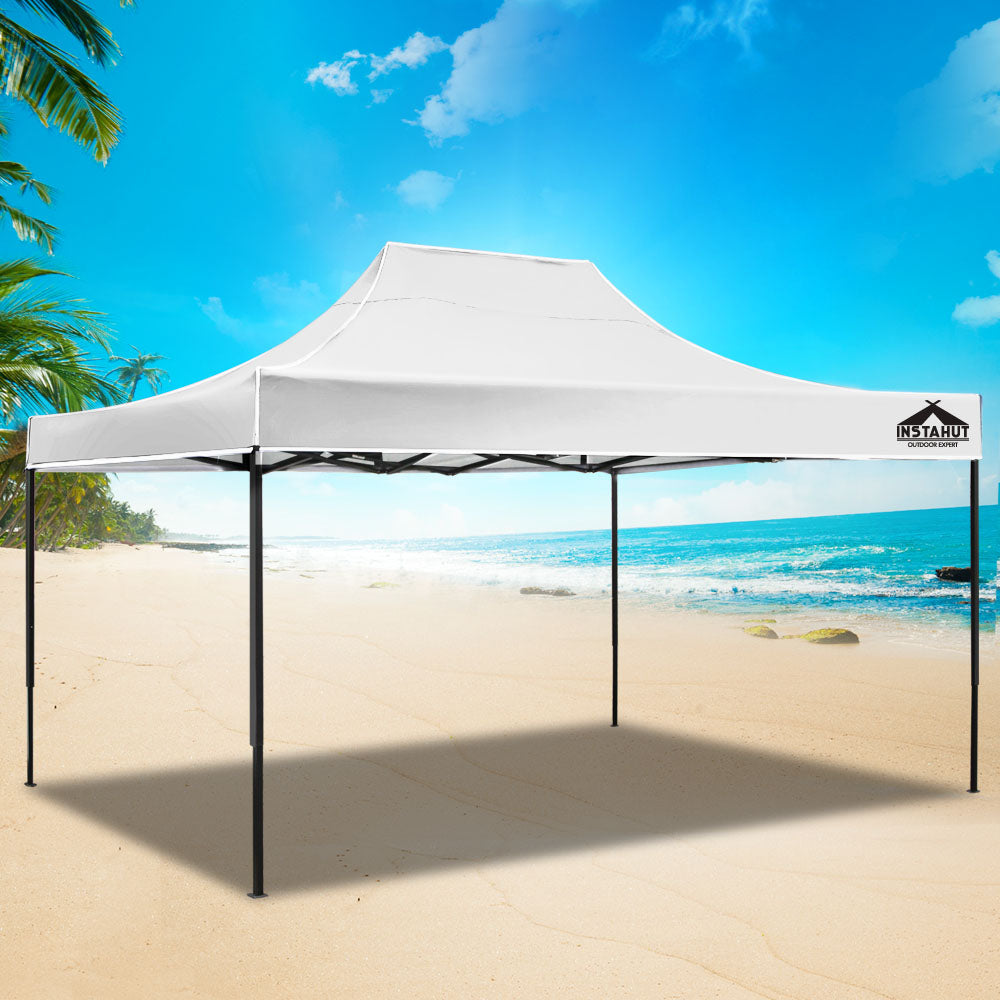 Pop-up marquee gazebo on sandy ground with white canopy and black side frame