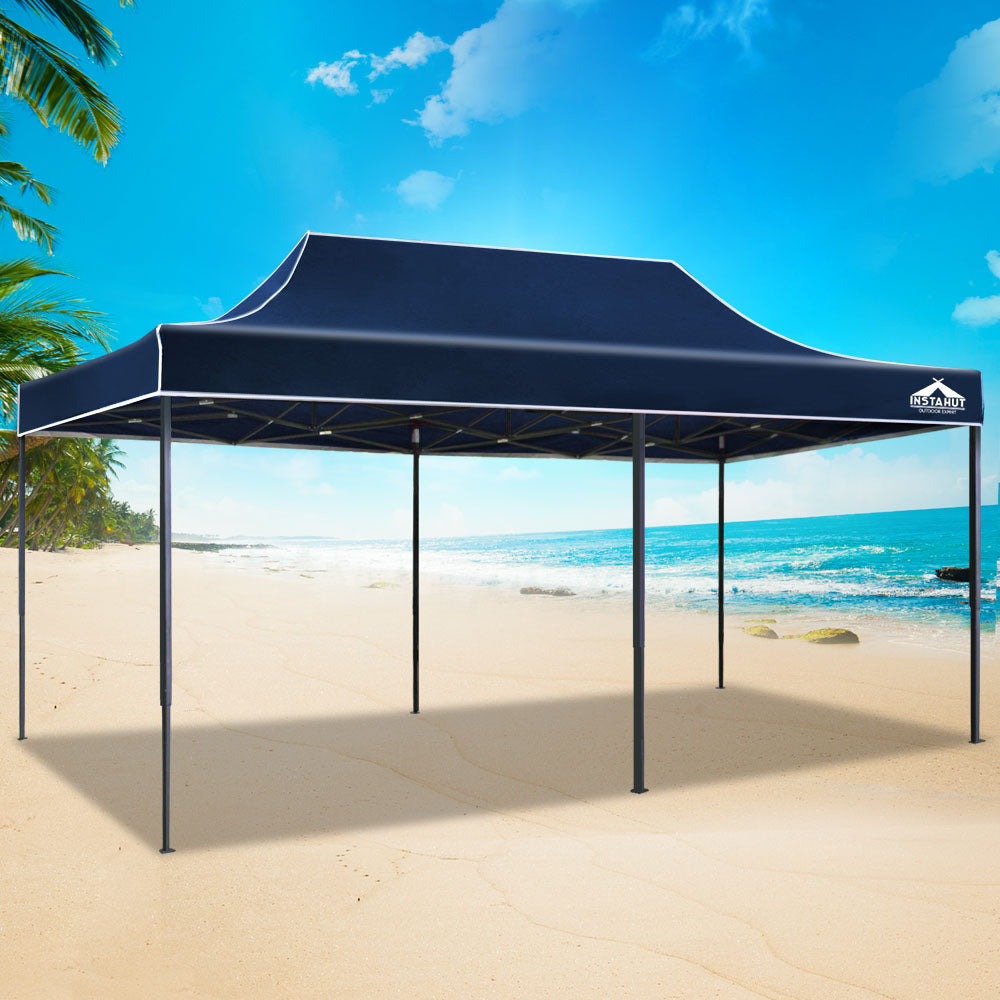 Navy pop-up gazebo tent with sloped canopy roof, open sides, steel frame posts