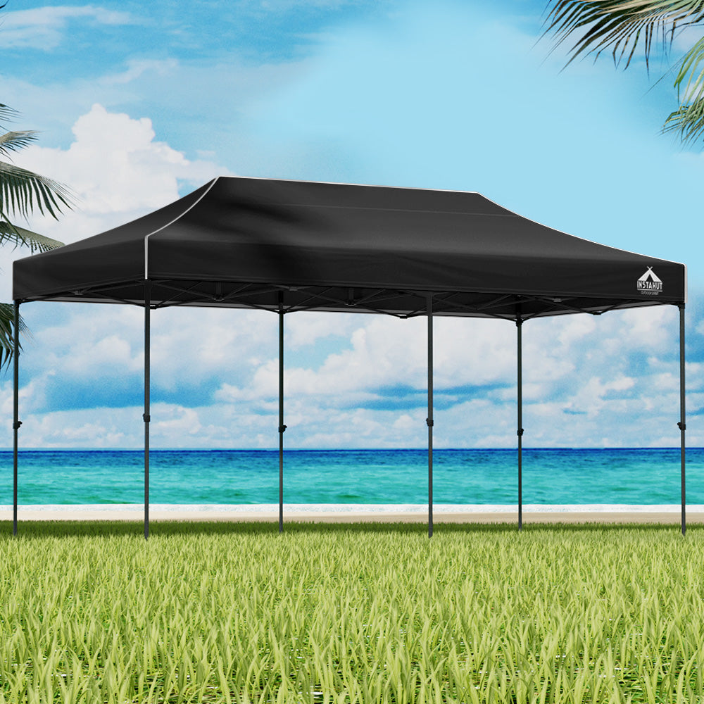 Navy pop-up gazebo tent with peaked canopy and open side panels